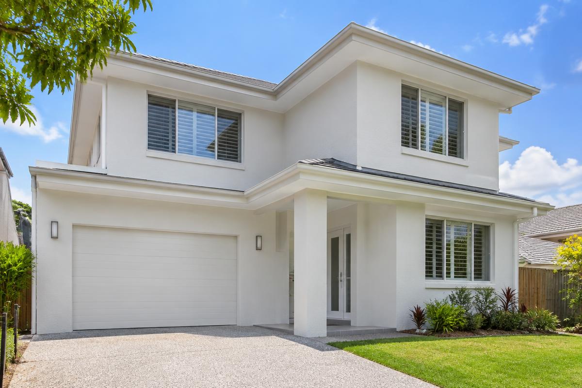 Clean home exterior with a fresh driveway, ready for sale